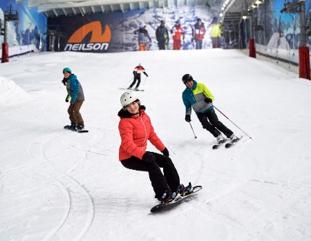 Skiers and snowboarders on an indoor slope at Hemel Hempstead
