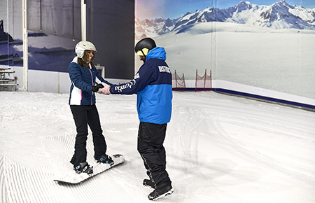 Lady on a Beginner Snowboard Lesson